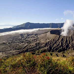 Smoke billowing from Mount Bromo volcano. View from the summit of Mount Batok