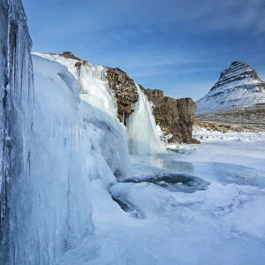 Snow covered Kirkjufell Mountain and frozen waterfalls, , Snaefellsness Peninsula