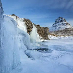 Snow covered Kirkjufell Mountain and frozen waterfalls, , Snaefellsness Peninsula