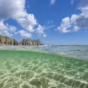 Split-level view of Logan Rock and coastline along Pedn Vounder beach, Cornwall, UK. May, 2021