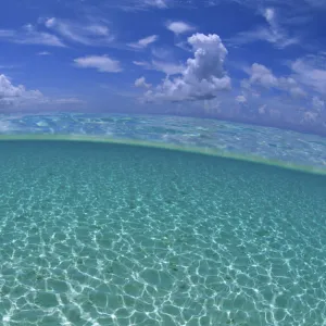 A split level view of shallow water and clouds in summer, Seven Mile Beach, Grand Cayman