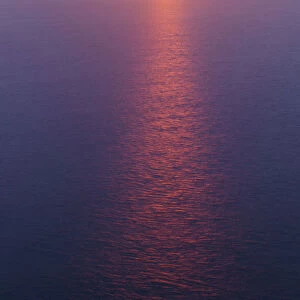 Sun reflected in sea at sunset, viewed from the Cliffs of Moher, The Burrren, County Clare