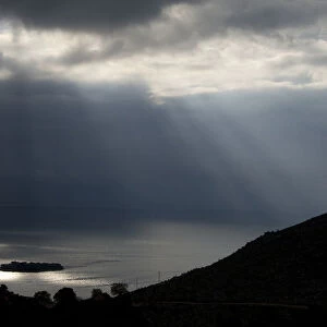 Sun shining through clouds over Lake Skadar near Murici, Lake Skadar National Park