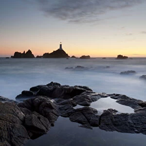 Sunset views of La Corbiere lighthouse located at the extreme south-western point of