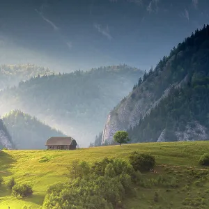 Traditional barn on hilltop in mountain landscape, Magura, Brasov County, Carpathian mountains, Romania. July, 2021