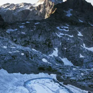 Upper Kriz Lake with ice melting, Mount Triglav (2, 864m) in the distance, Triglav National Park Upper Kriz Lake with ice melting, Mount Triglav (2, 864m) in the distance, Triglav National Park