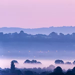 View towards Glastonbury Tor with low lying mist at dawn from Waltons Hill, Glastonbury