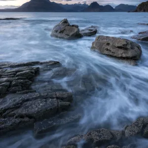 Waves washing up Elgol beach in the evening light with a view of the Cuillins, Strathaird