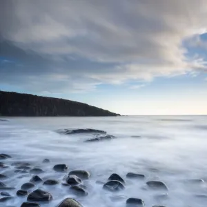 Waves washing over the rocks, Cullernose Point at dawn, Northumberland, UK. March 2014