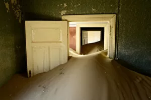 Arid Gallery: Abandoned house full of sand. Kolmanskop Ghost Town, an old diamond-mining town where