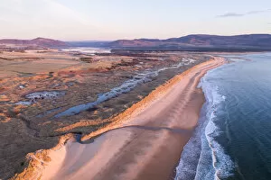 July 2022 Highlights Collection: Aerial view of coastline and Coul Links sand dune system at sunrise, Sutherland, Scotland