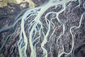 Aerial view of a glacier river flowing from glacier which is melting at an unprecedented pace due to rising