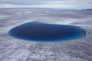 Aerial view of meltwater lake on the ice cap north-east of Sermeq Kujalleq Glacier
