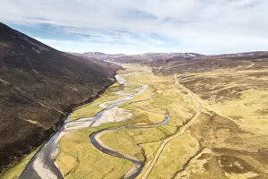 Aerial view of the upper River Dulnain running through open moorland, Monadhliath mountains, Highlands, Scotland, UK