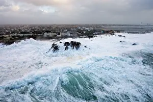 Bretagne Prints: Aerial view of waves crashing long the coast of Saint-Guenole in bad weather