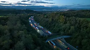 Automobile Prints: Aerial view of a wildlife crossing over the A7 highway at dusk
