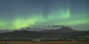 Aurora borealis in the evening sky over Ben Ledi from Buchlyvie, The Trossachs National Park, Stirling, Scotland Aurora borealis in the evening sky over Ben Ledi from Buchlyvie, The Trossachs National Park, Stirling, Scotland