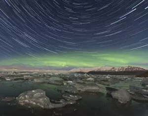 Aurora borealis and star trails over Jokulsarlon glacier lagoon. Southern Iceland