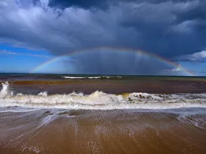 Wave Gallery: Autumn high tides with stormy skies and rainbow over the sea, Walcott, Norfolk, England