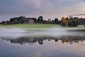 Berrington Hall reflected in lake at dawn, Herefordshire, England, UK, October 2015