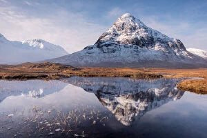 Mountains Collection: Buachaille Etive Beag reflected in Lochan na Fola after snowfall, early morning light, Glencoe