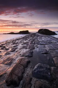 Bude breakwater at sunset, Bude, North Cornwall, UK. August 2008
