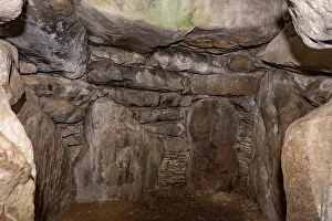 Monuments Prints: The chamber of West Kennet Long Barrow built with sarsen stones featuring the back of the main chamber
