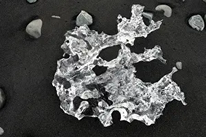 Volcano Prints: Clear crystal ice on the black sands of Diamond Beach