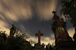 London Prints: Clouds in the night sky above gravestones