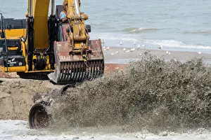 Equipment Prints: Crawler hydraulic excavator used for sand replenishment / beach nourishment to reduce storm damage along the Dutch