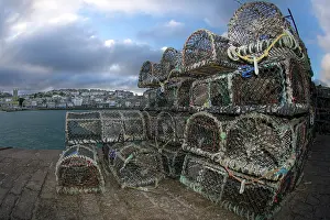 Equipment Prints: Creel lobster pots stacked on harbour wall, St.Ives, Cornwall, UK. December