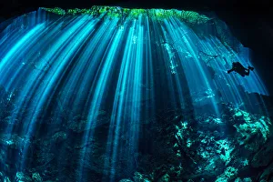 Diver exploring a freshwater cenote (or limestone sinkhole