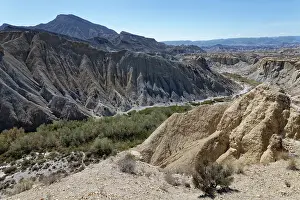 Almeria Prints: Dry river bed flanked by badlands of alluvial marl and clay deposits heavily eroded by seasonal water flow