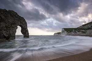 Arch Gallery: Durdle Door, with incoming tide at sunset, near Lulworth, Dorset Jurassic coast, UK