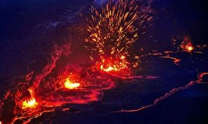Eruption and molten lava flowing down the sides of the Erta ale volcano (the smoking