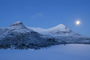 European river otter (Lutra lutra) footprints crossing frozen Loch Lurgainn at dawn