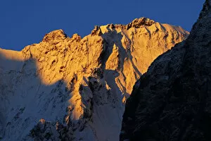 First light on snow covered mountain near Dombay, Teberdinsky biosphere reserve, Caucasus