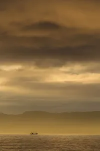 Working Boats Prints: Fishing boat silhouetted at sunset, The Minch, a stretch of water between NW Highlands