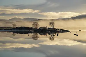 Cold Weather Prints: Frosty trees reflecting in a loch on a misty morning with moorland behind