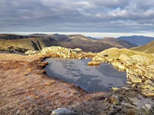 Summit Prints: Frozen tarn on Glaramara mountain summit, Lake District, Cumbria, UK. December, 2022
