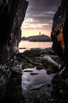 Images Dated 22nd June 2009: Godrevy Lighthouse at sunset, seen through rocksand rockpool in the foreground. Nr Hayle