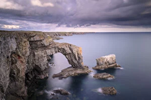 Arches Gallery: The Green Bridge of Wales sea arch and stack along limestone coastline