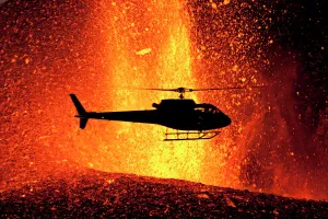 Iceland Prints: Helicopter flying over volcanic eruption near Eyjafjallajoekull glacier, Iceland