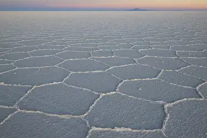 Hexagonal shapes on surface of salt flats at sunrise, Salar de Uyuni, Altiplano, Potosi, Bolivia. September, 2024