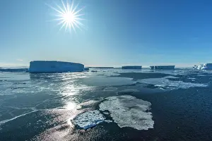 Iceberg Prints: Huge icebergs under bright sunshine at entrance to Pine Island Bay