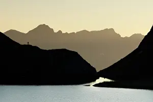 Sunset Prints: Ibon de Catieras and mountains backlit at sunset, Pyrenees, Huesca, Spain. August, 2024