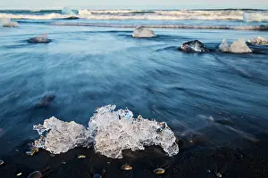 Volcano Prints: Ice on black, volcanic sand beach with waves on glacial lake
