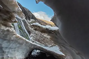 Chubut Prints: Ice tunnel adjacent to a waterfall above the treeline in Los Alerces National Park