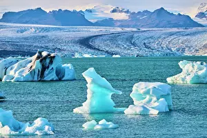 Iceberg Prints: Icebergs floating on glacial lagoon with glacier in background
