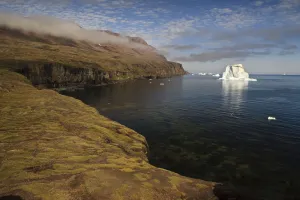 Images Dated 18th August 2009: Icebergs just off the coast with low clouds over the cliffs, Qeqertarsuaq, Disko Bay